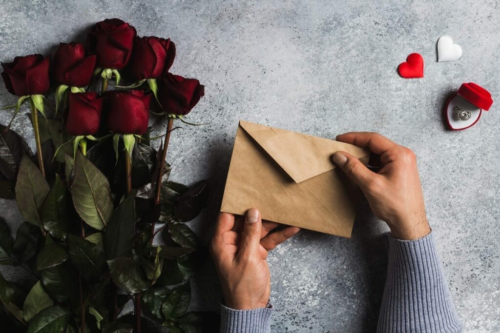 Blog valentines day man hand holding envelope love letter with greeting card
