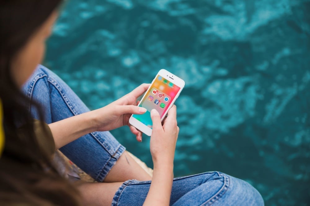 Blog woman using cellphone with social media notifications screen